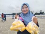 Tengku Nor Atikah Tengku Nazri bersama bungkusan jualan jagung rebus di Pantai Balok, Kuantan Pahang pada 10 September 2022. Foto : EDISI 9 / MOHD NAIM AZIZ