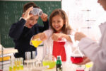 Smart pupils making experiment in chemistry class