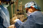 200423-N-LL146-1023 NEW YORK (April 23, 2020) – Lt. Cmdr. Gabriel Santiago, right, Lt. Cmdr. Scott Zuckerman perform a surgery aboard the hospital ship USNS Comfort (T-AH 20). Comfort cares for critical and non-critical patients without regard for their COVID-19 status. Comfort is working with the Javits New York Medical Station as an integrated system to relieve the New York City medical system, in support of the U.S. Northern Command’s Defense Support of Civil Authorities as a response to the COVID-19 pandemic. (U.S. Navy photo by Mass Communication Specialist 1st Class Scott Bigley)